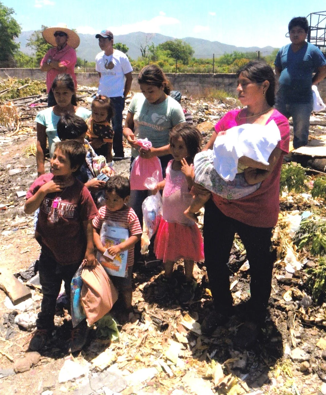 Family living near dump in Guatamala receiving our bags.